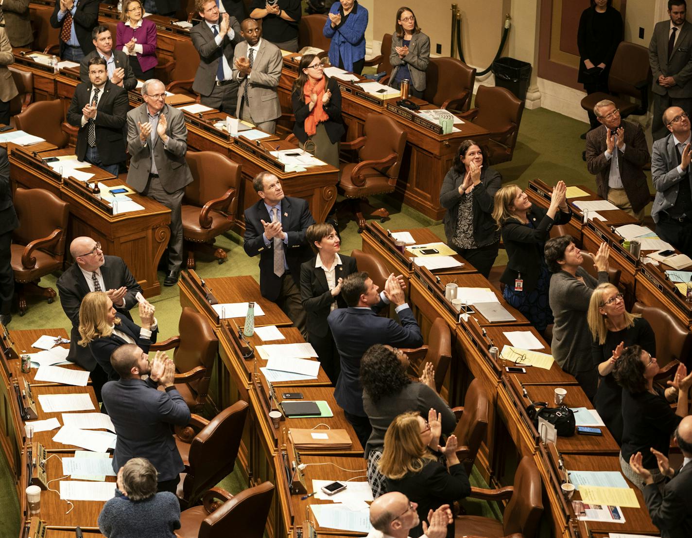 Members of the House of Representatives applauded Jennifer Teeson after they unanimously passed a bill that would immediately allowed the law to recognize that a spouse can be prosecuted for raping their spouse. Photographed at the State Capitol in St. Paul, Minn., on Thursday, February 21, 2019. Teeson had testified about her rape. She was drugged and raped by her husband and did not realize it until she found a video recording of the attack on his computer. Because of current law he could not