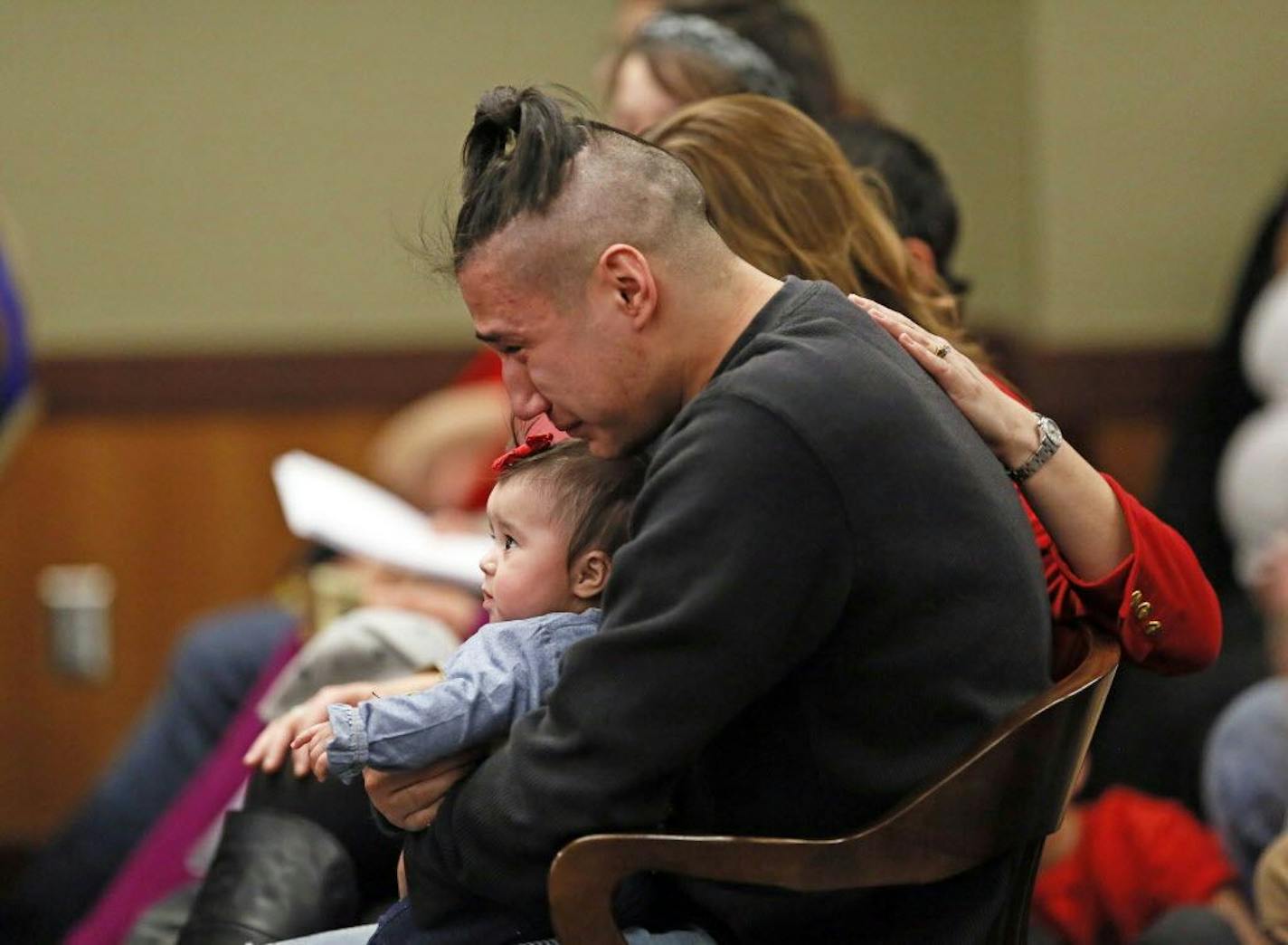 Savanna LaFontaine-Greywind's boyfriend Ashston Matheny holds their daughter, Haisley Jo, as victim impact statements are read during the sentencing of Brooke Crews at the Cass County District Court on Friday, Feb. 2, 2018.
David Samson / The Forum