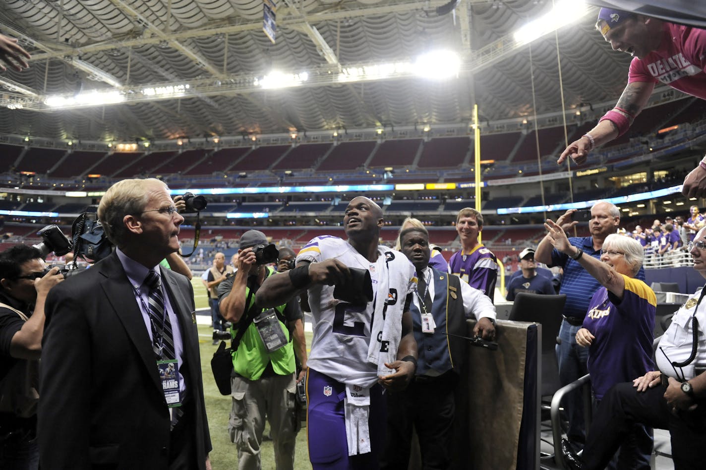 Minnesota Vikings running back Adrian Peterson smiles following the Vikings' 34-6 victory over the St. Louis Rams in an NFL football game Sunday, Sept. 7, 2014, in St. Louis. (AP Photo/L.G. Patterson)