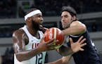 United States' DeMarcus Cousins (12) is pressured by Argentina's Luis Scola (4) during a men's quarterfinal round basketball game at the 2016 Summer O