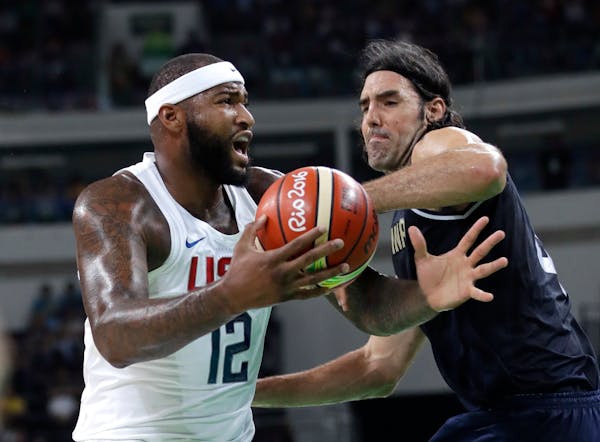 United States' DeMarcus Cousins (12) is pressured by Argentina's Luis Scola (4) during a men's quarterfinal round basketball game at the 2016 Summer O