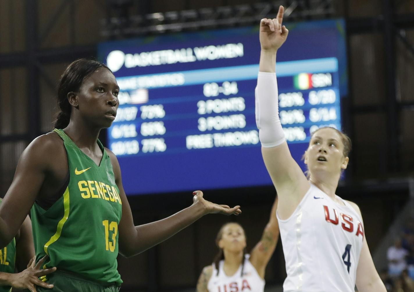 Senegal center Oumou Toure (13) looks toward the referee as United States guard Lindsay Whalen signals a basket during the second half of a women's basketball game at the Youth Center at the 2016 Summer Olympics in Rio de Janeiro, Brazil, Sunday, Aug. 7, 2016. The United States defeated Senegal 121-56. (AP Photo/Carlos Osorio)