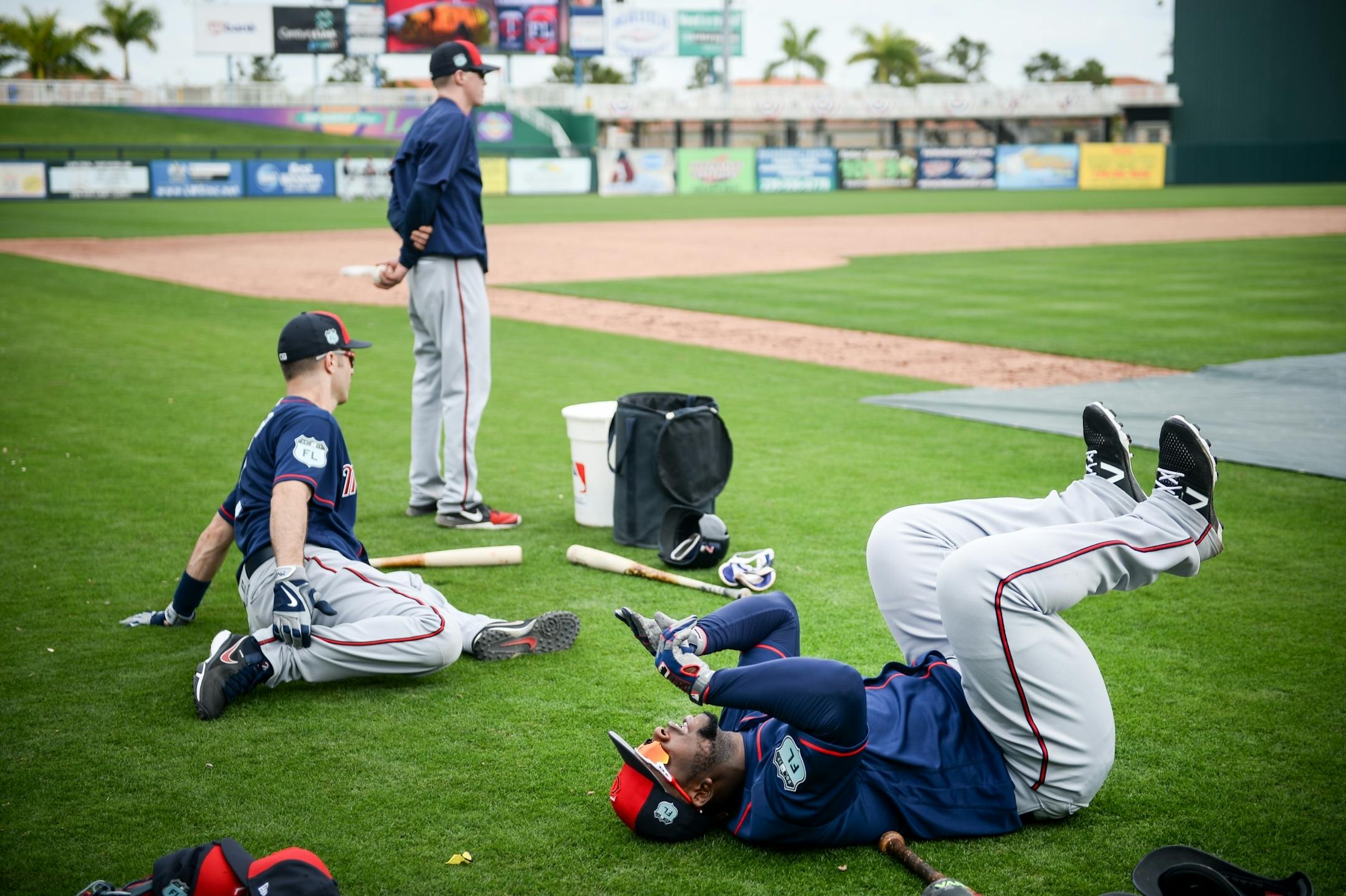 Minnesota Twins third baseman Miguel Sano (22) played dead on his back as first baseman Joe Mauer stretched before batting practice.