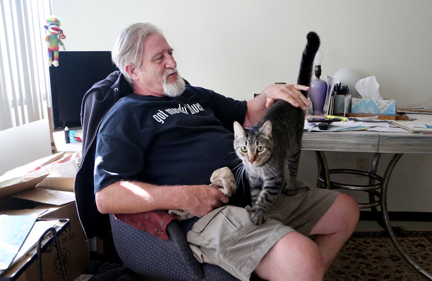 For weeks, Bill McConnell couch surfed and slept in his car after he was forced out of his manufactured home in Lowry Grove, St. Anthony's only mobile home park that closed June 30. Now he got some public help getting an apartment and has moved into his northeast Minneapolis apartment.Here, McConnell was seen with his tabby cat Spotty, 2, whom he was separated from after leaving Lowry Grove until he got his apartment and seen Thursday, Aug. 31, 2017, in Minneapolis, MN.] DAVID JOLES &#xef; david