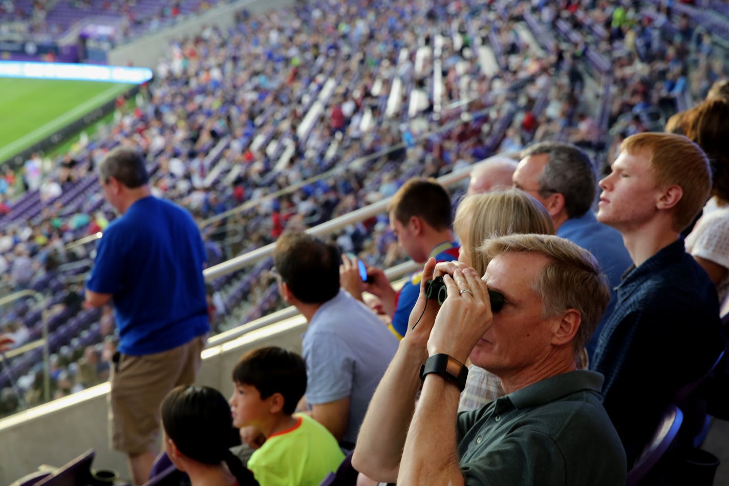 Mitch Hagen got a view of the stadium with binoculars from his seat at U.S. Bank Stadium for the first game played at the new facility on Wednesday, August 3, 2016.