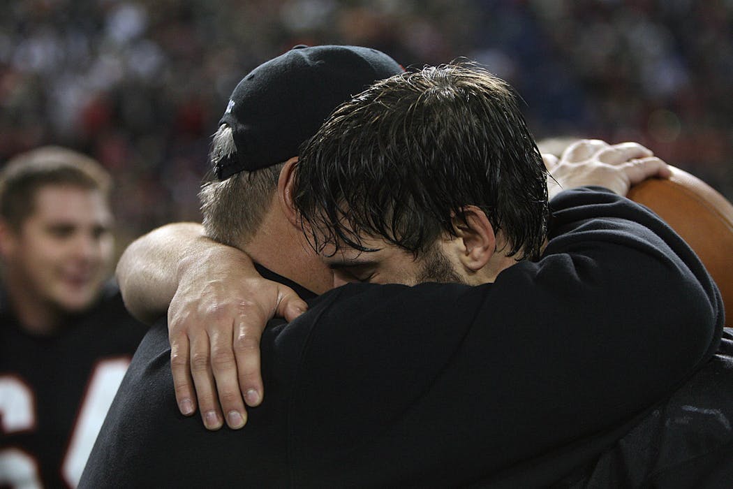 Eden Prairie coach Mike Grant and quarterback Ryan Grant embraced, a father and son celebrating victory.