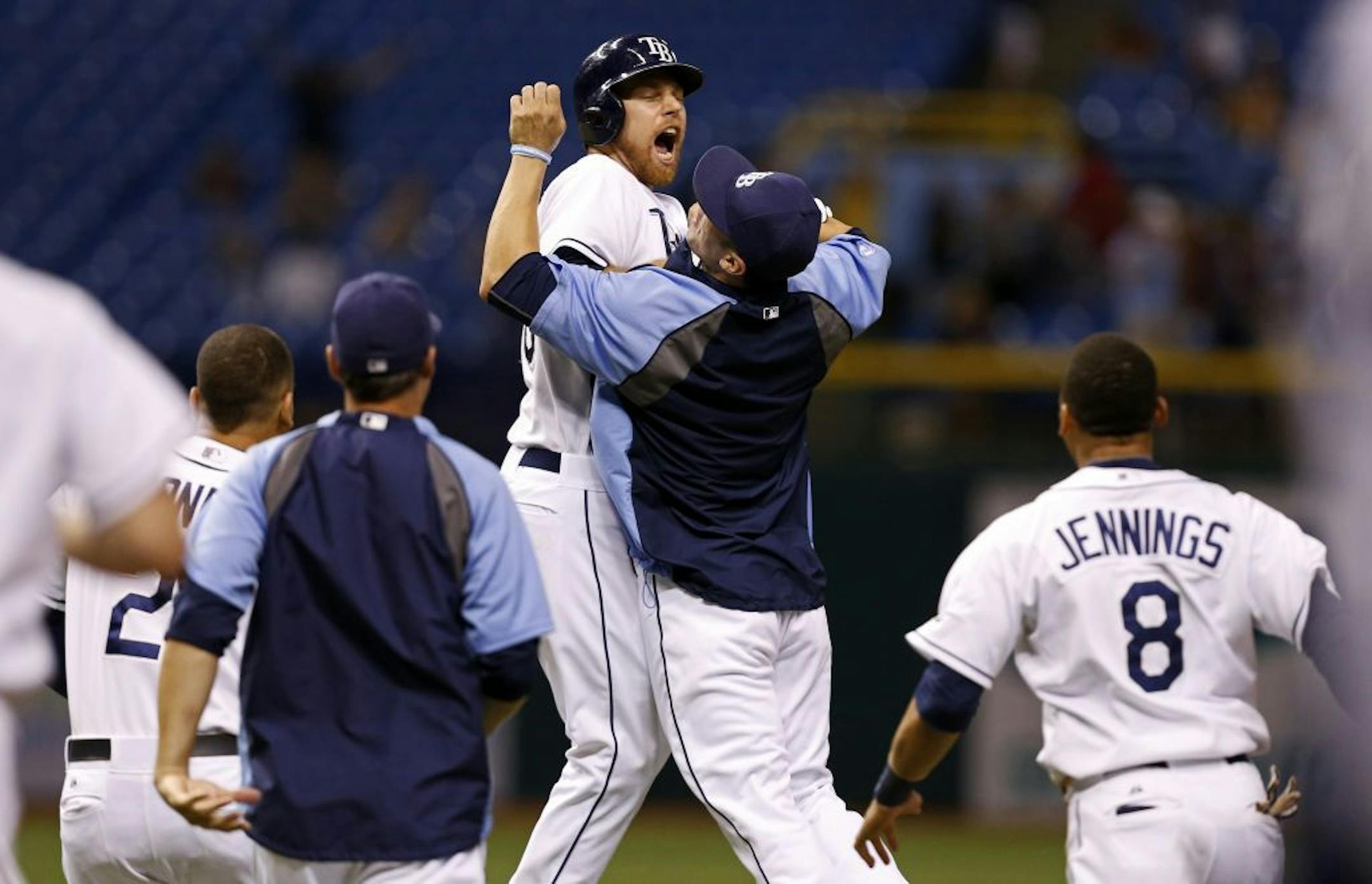 Ben Zobrist, left, celebrates with teammate Sean Rodriguez after driving in the game-winning run in the bottom of the 13th inning of a game against the Twins Wednesday, July 10, 2013, in St. Petersburg, Fla. The Rays won 4-3.