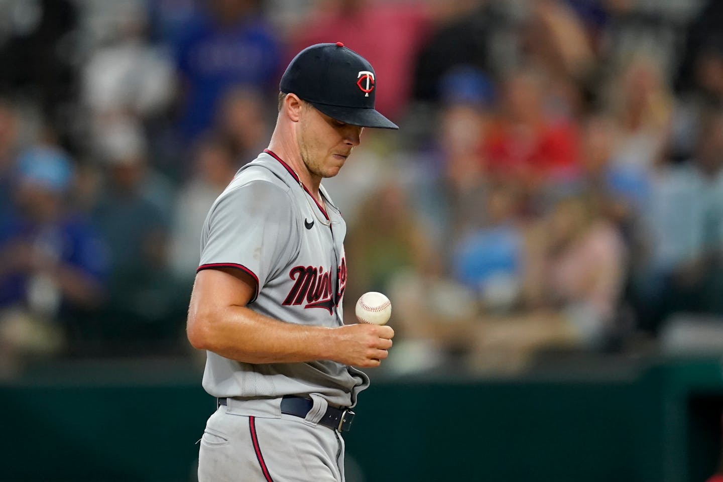 Minnesota Twins' Sonny Gray steadies the ball on his hand after catching it as he waits on the mound before turning it over to manager Rocco Baldelli in the fifth inning of a baseball game against the Texas Rangers, Friday, July 8, 2022, in Arlington, Texas. (AP Photo/Tony Gutierrez)