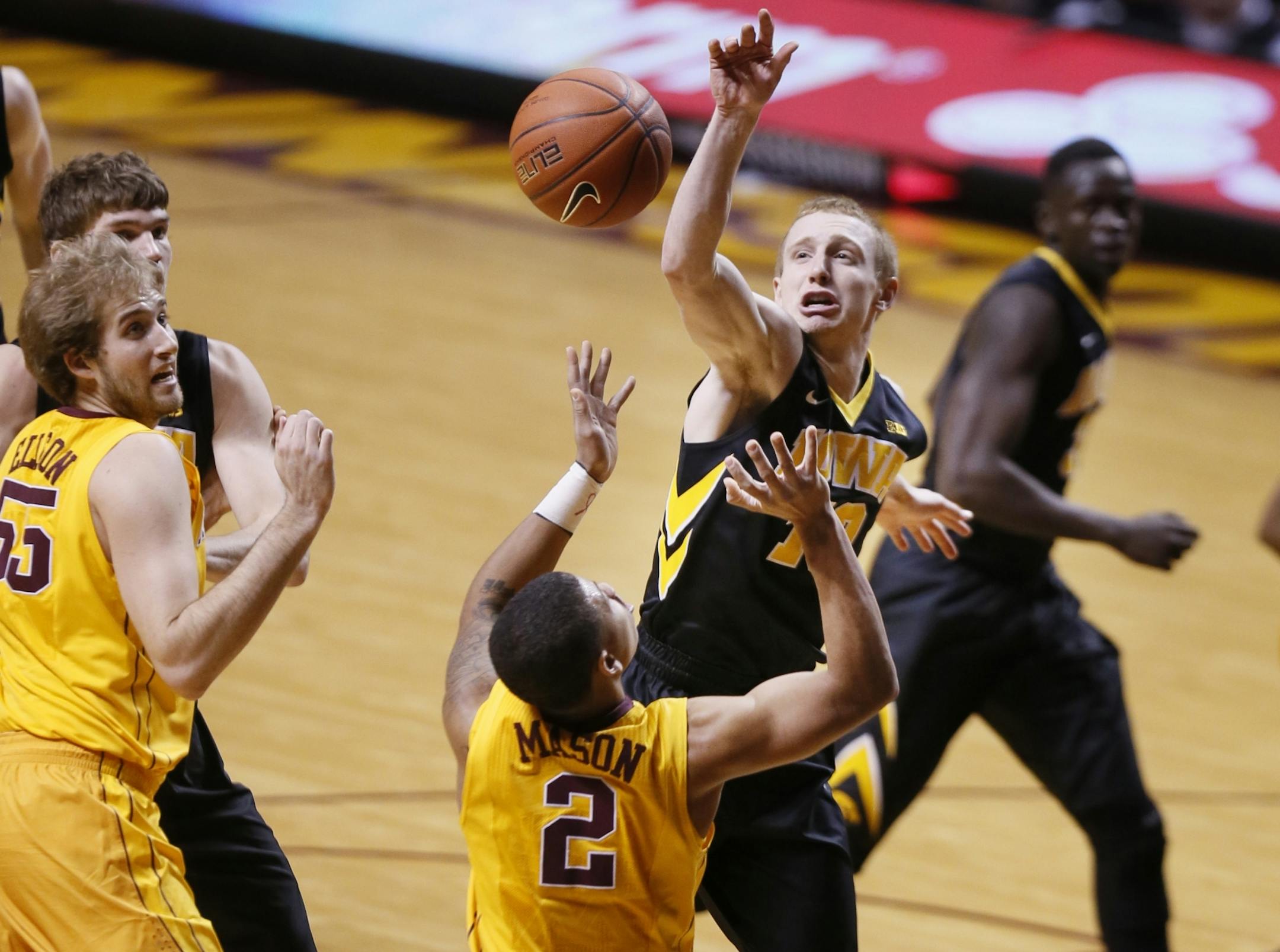 Iowa Hawkeyes guard Mike Gesell (10) blocked the shot of Minnesota Gophers guard Nate Mason (2) Tuesday at Williams arena January 13, 2015 Minneapolis, MN.