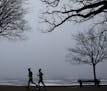Runners made their way around Lake Hariett as the dense fog loomed above the lake early Thursday, February 2, 2012 in Minneapolis, MN.(ELIZABETH FLORE