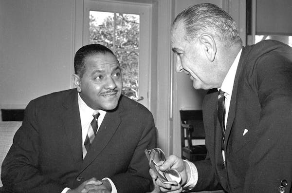 U.S. President Lyndon Johnson talks with Carl Rowan at the White House in Washington, D.C., Jan. 21, 1964. Rowan, 38, currently the U.S. Ambassador to
