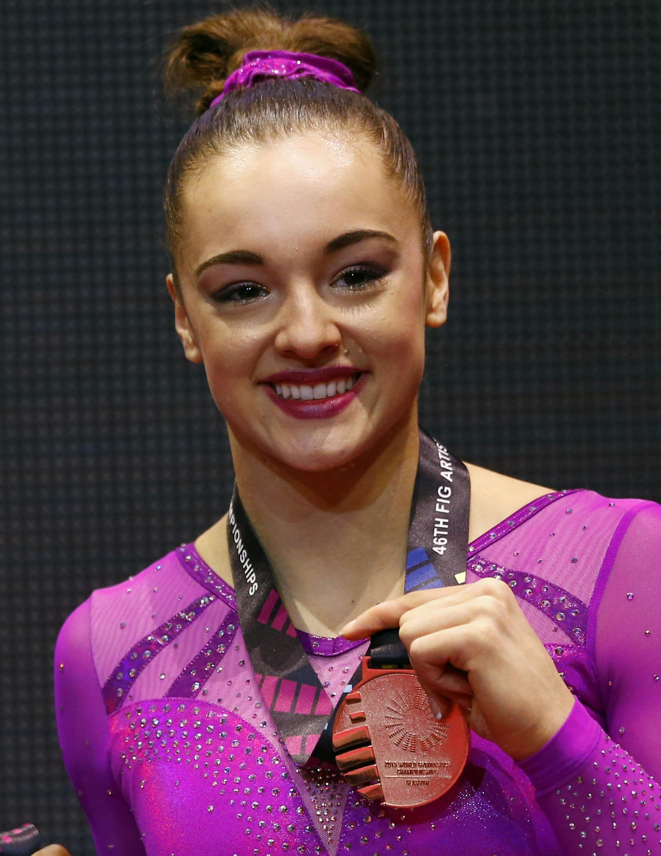 Gold medal winner Simone Biles of the U.S., center, silver medal winner Russia&#xed;s Kseniia Afanaseva, left, and bronze medal winner Maggie Nichols of the U.S. pose on the podium after the balance beam exercise during the women's apparatus final competition at the World Artistic Gymnastics championships at the SSE Hydro Arena in Glasgow, Scotland, Sunday, Nov. 1, 2015. (AP Photo/Matthias Schrader) ORG XMIT: MIN2015111319392999