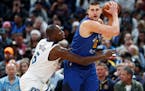 Gorgui Dieng (left, defending against Nuggets center Nikola Jokic) has stepped up as a Timberwolves starter in Towns' absence, averaging 15.3 points a
