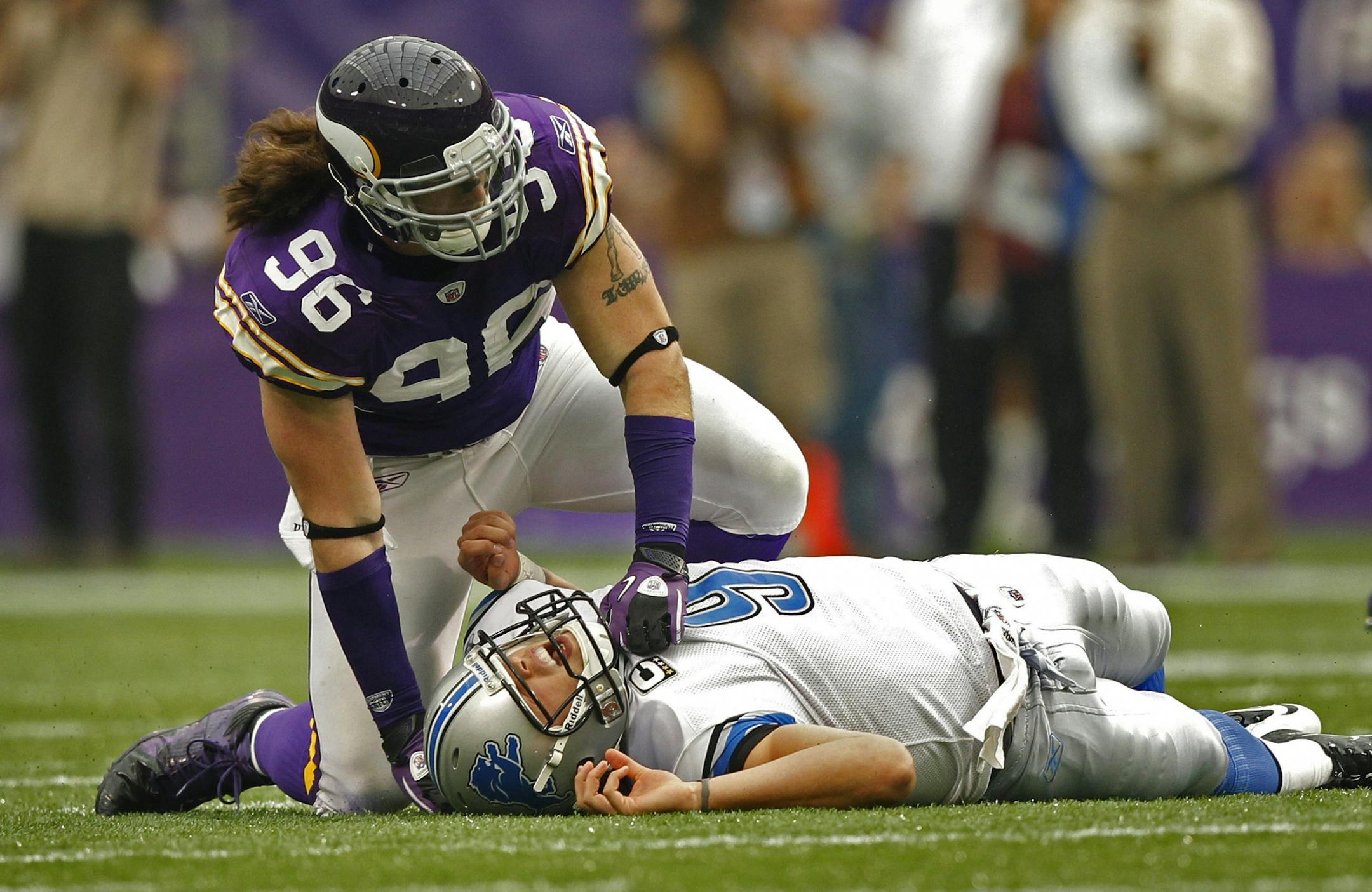 Minnesota's Brian Robison (96) hovers over Detroit Lions quarterback Matthew Stafford in September 2011.