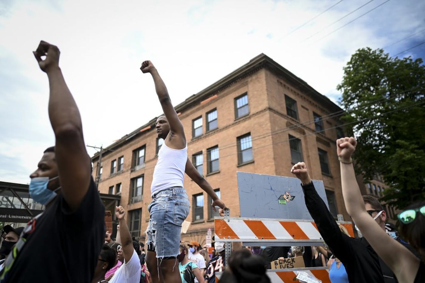 Kenneth St. Julien, of south Minneapolis, raised his fist in the air after listening to Thursday's private memorial service for George Floyd in the street. "I'm so glad this is waking America up," said St. Julien of the aftermath of Floyd's death. St. Julien says he was arrested outside Bobby and Steves last week downtown. The rioting has been hard to watch, but St. Julien says he's been more focused on the positives of the community coming together for cleanups and donations. "That is what Minn