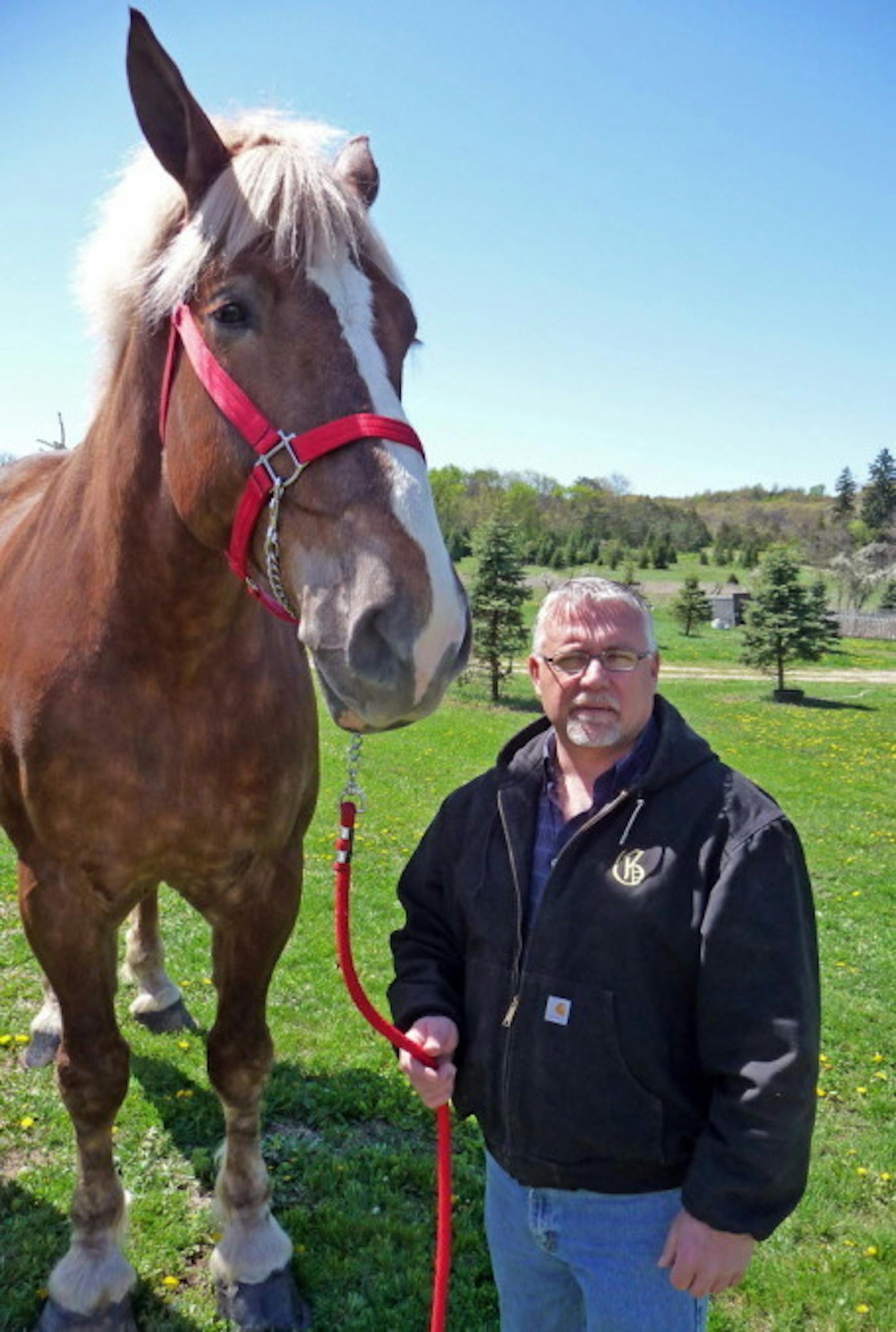 Jerry Gilbert stands next to Big Jake at the Smokey Hollow Farm in Wisconsin. Photo by Carrie Antlfinger, AP