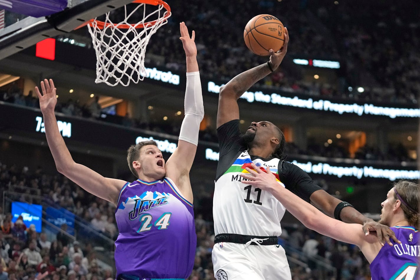 Minnesota Timberwolves center Naz Reid (11) goes to the basket as Utah Jazz center Walker Kessler (24) defends during the first half of an NBA basketball game Wednesday, Feb. 8, 2023, in Salt Lake City. (AP Photo/Rick Bowmer)