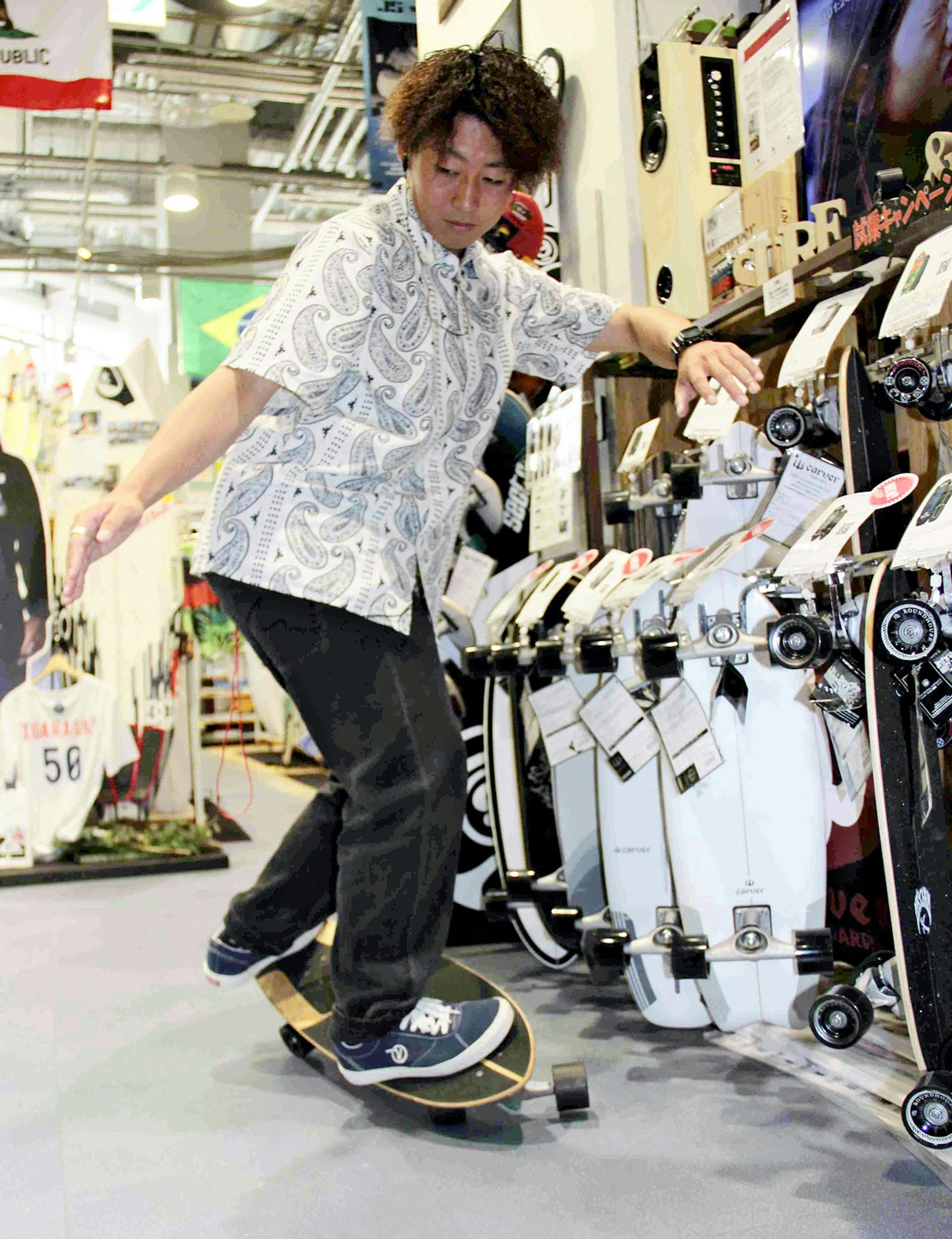 A man test-rides a surf skateboard at the Murasaki Sports Queen's Square store in Yokohama, Japan. MUST CREDIT: The Japan News/Yomiuri