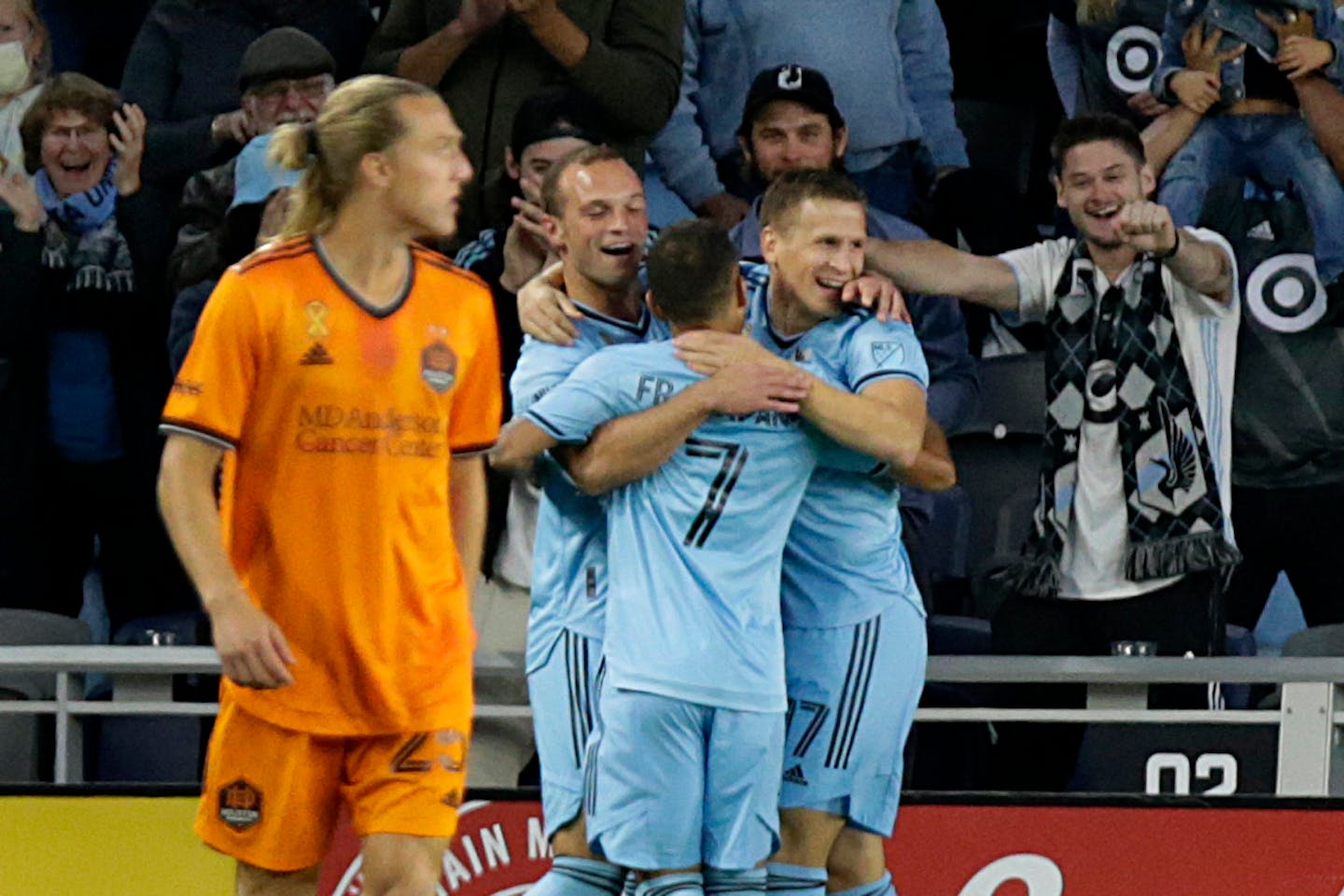 Minnesota United midfielder Robin Lod (17) celebrates with teammates Franco Fragapane (7) and Chase Gasper (77) after scoring as Houston Dynamo midfielder Griffin Dorsey (25) looks on during the first half of an MLS soccer match Saturday, Sept. 25, 2021, in St. Paul, Minn. (AP Photo/Andy Clayton-King)