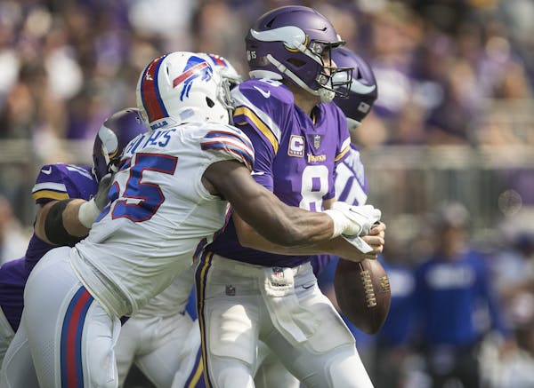 Minnesota Vikings quarterback Kirk Cousins (8) fumbles the football after he is hit by Buffalo Bills defensive end Jerry Hughes (55) on Sunday, Sept. 