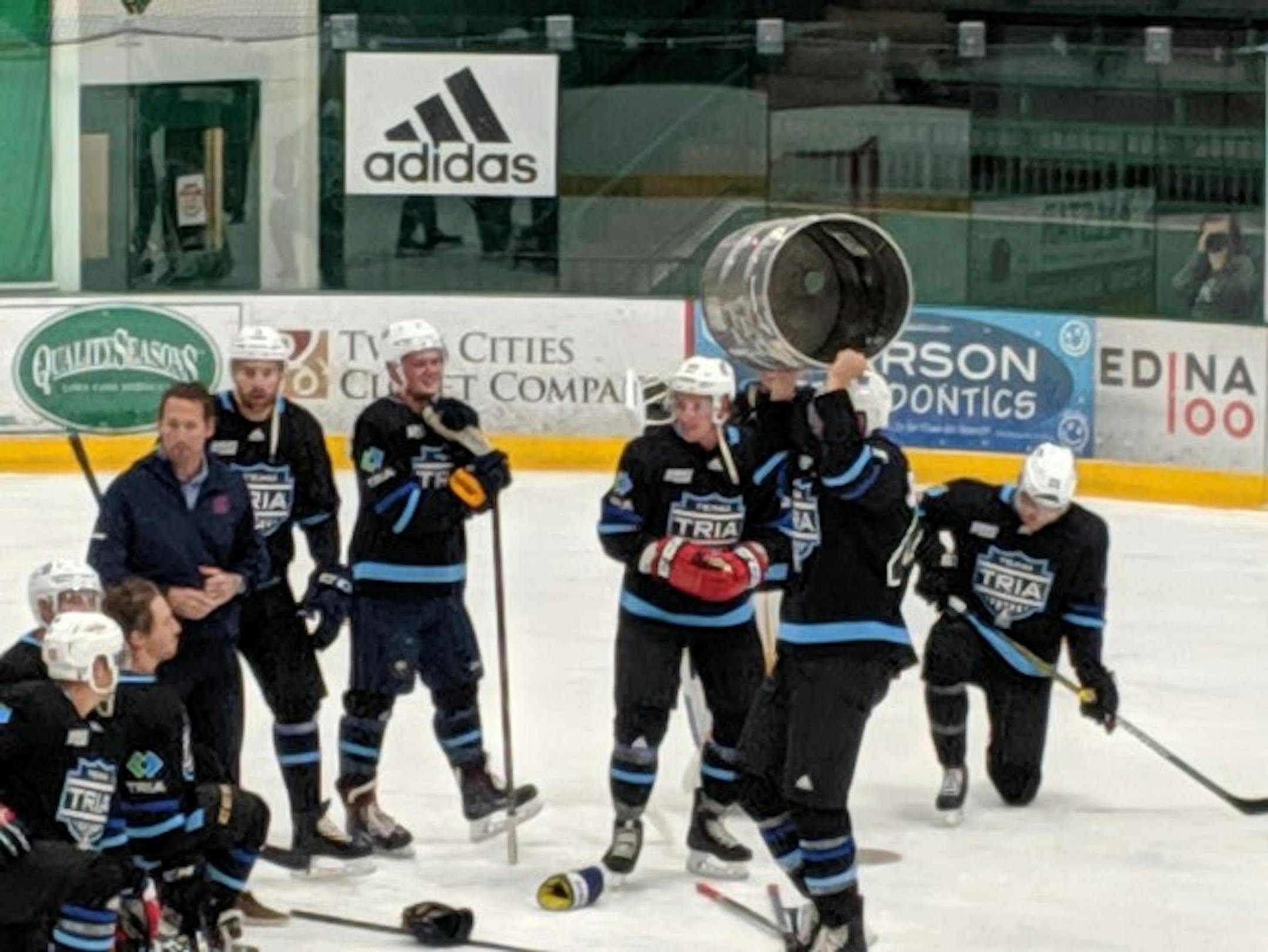 Members of the TRIA Orthopedics team celebrated with the John Scott Cup after winning Da Beauty League last August.