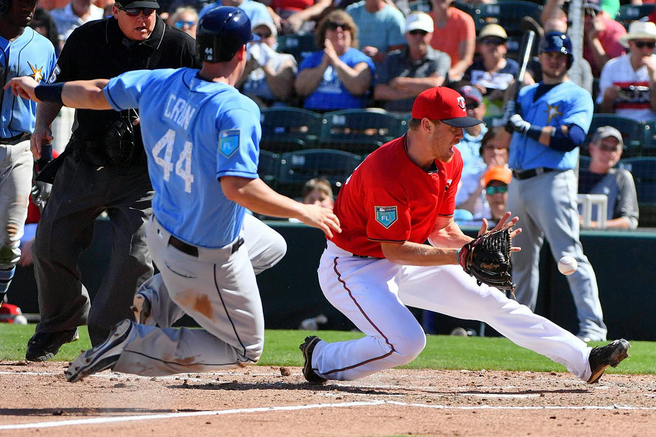 Twins minor league pitching prospect Casey Crosby (98) beat Rays infielder C.J. Cron (44) to home for an out to end their fourth inning.