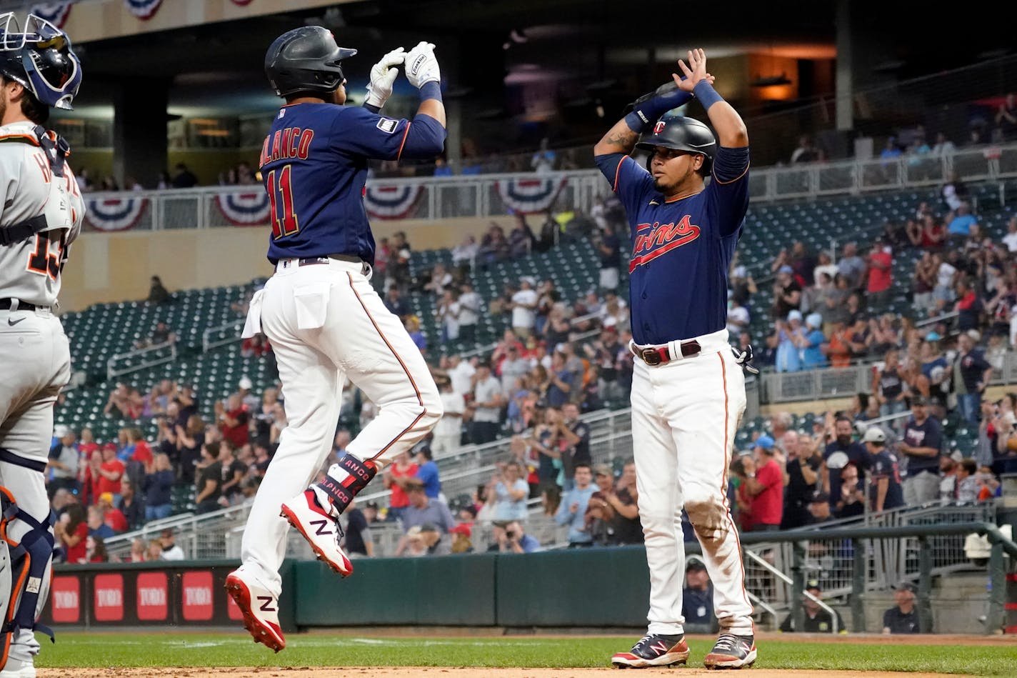 The Twins' Jorge Polanco, left, celebrates his three-run home run off Detroit Tigers pitcher Casey Mize with teammate Luis Arraez