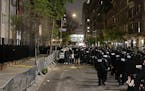 New York police officers move towards an entrance to Columbia University, Tuesday, April 30, 2024, in New York. After entering the campus, a contingen