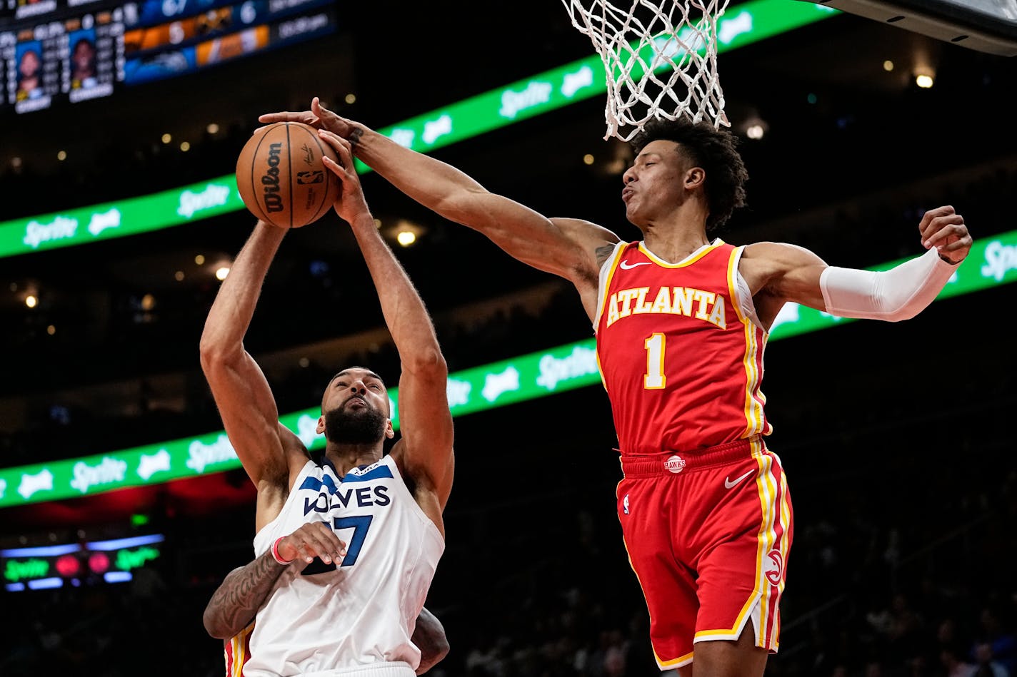 Minnesota Timberwolves center Rudy Gobert (27) is fouled as he goes up for a shot against Atlanta Hawks forward Jalen Johnson (1) during the second half of an NBA basketball game, Monday, Oct. 30, 2023, in Atlanta. (AP Photo/John Bazemore)