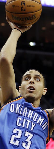 Oklahoma City Thunder's Kevin Martin (23) shoots over Memphis Grizzlies' Jerryd Bayless (7) during the first half of an NBA basketball game in Memphis
