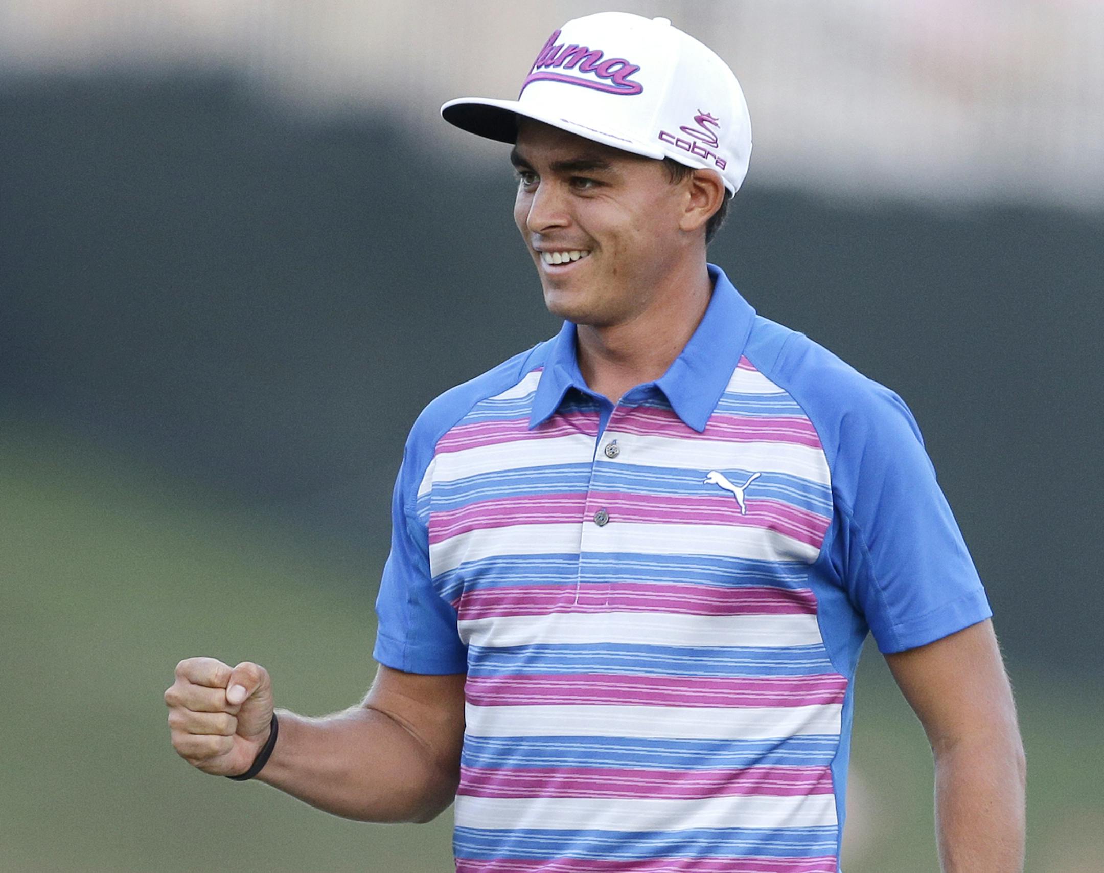 Rickie Fowler pumps his fist after winning The Players Championship golf tournament in a sudden death playoff against Kevin Kisner, Sunday, May 10, 2015, in Ponte Vedra Beach, Fla. (AP Photo/Chris O'Meara)