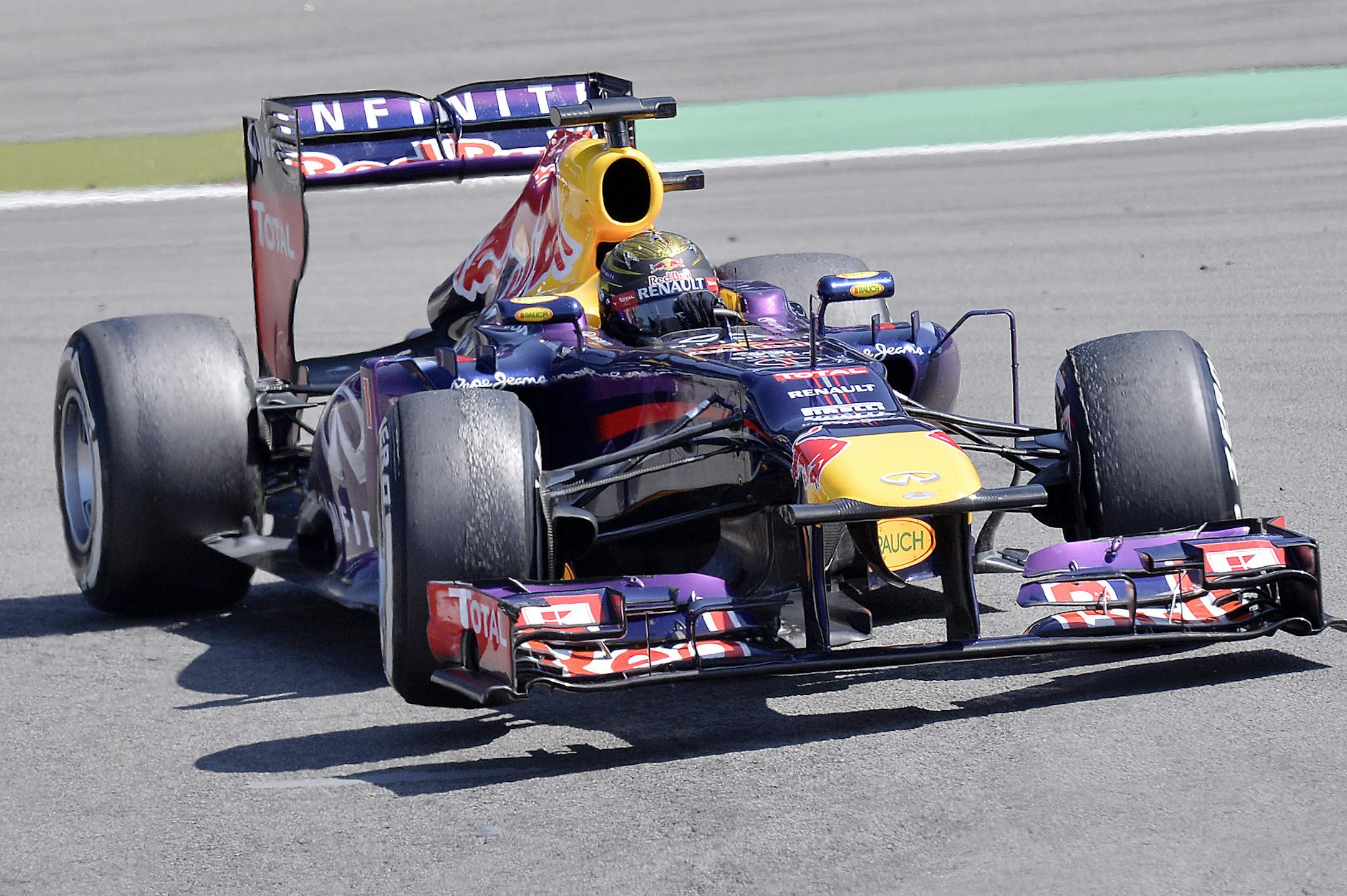 Red Bull driver Sebastian Vettel of Germany steers his car during the German Formula One Grand Prix at the Nuerburgring racetrack, in Nuerburg, Germany, Sunday, July 7, 2013. Vettel won the race ahead of Lotus drivers Kimi Raikkonen of Finland and Romain Grosjean of France. (AP Photo/Martin Meissner)