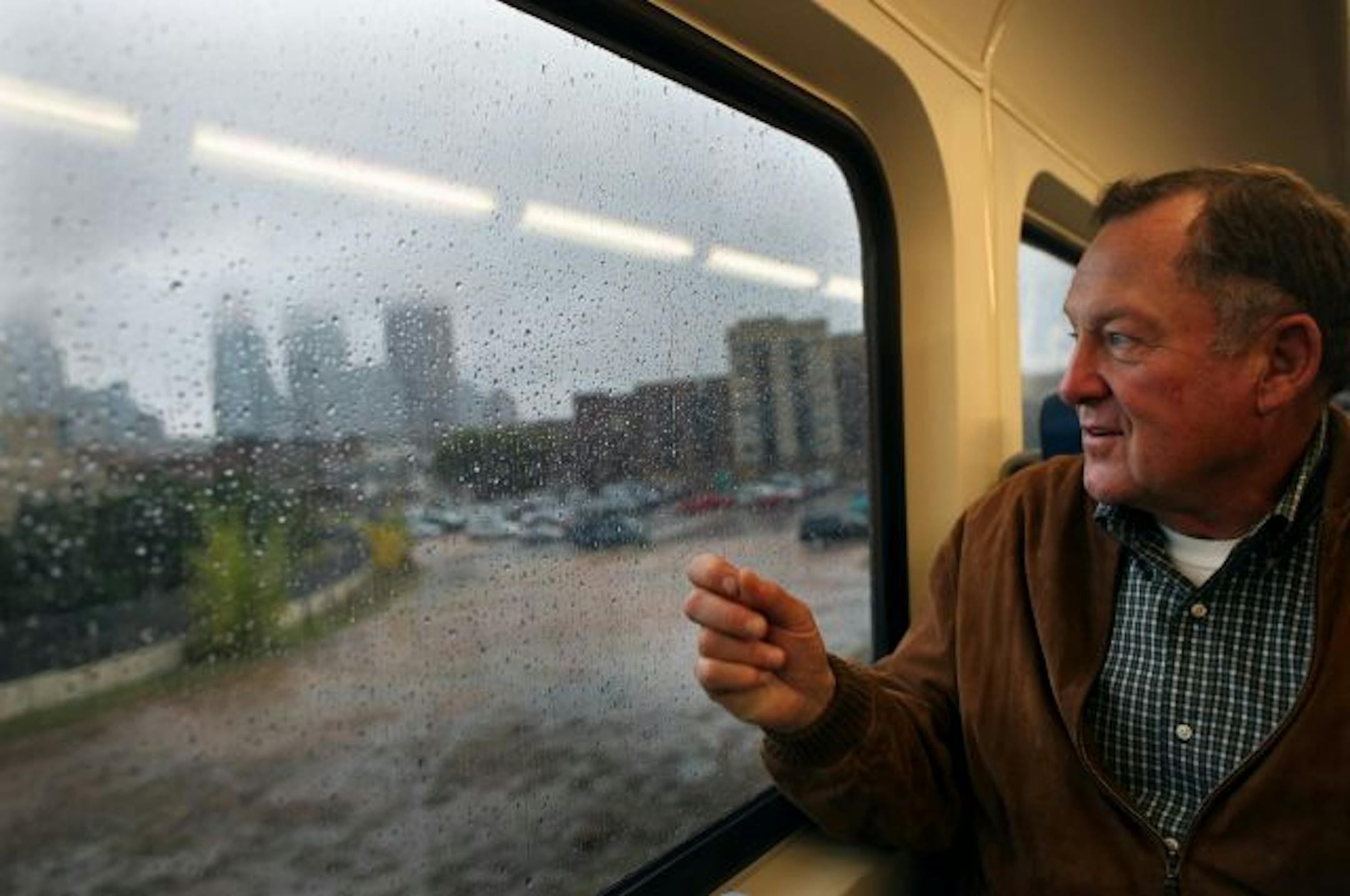 Metropolitan Council member Roger Scherer took in the view of Minneapolis from the new Northstar commuter rail line after it crossed the Mississippi into downtown.