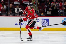 Chicago Blackhawks left wing Lukas Reichel (27) warms up with teammates before an NHL hockey game against the Montreal Canadiens in Chicago, Thursday,