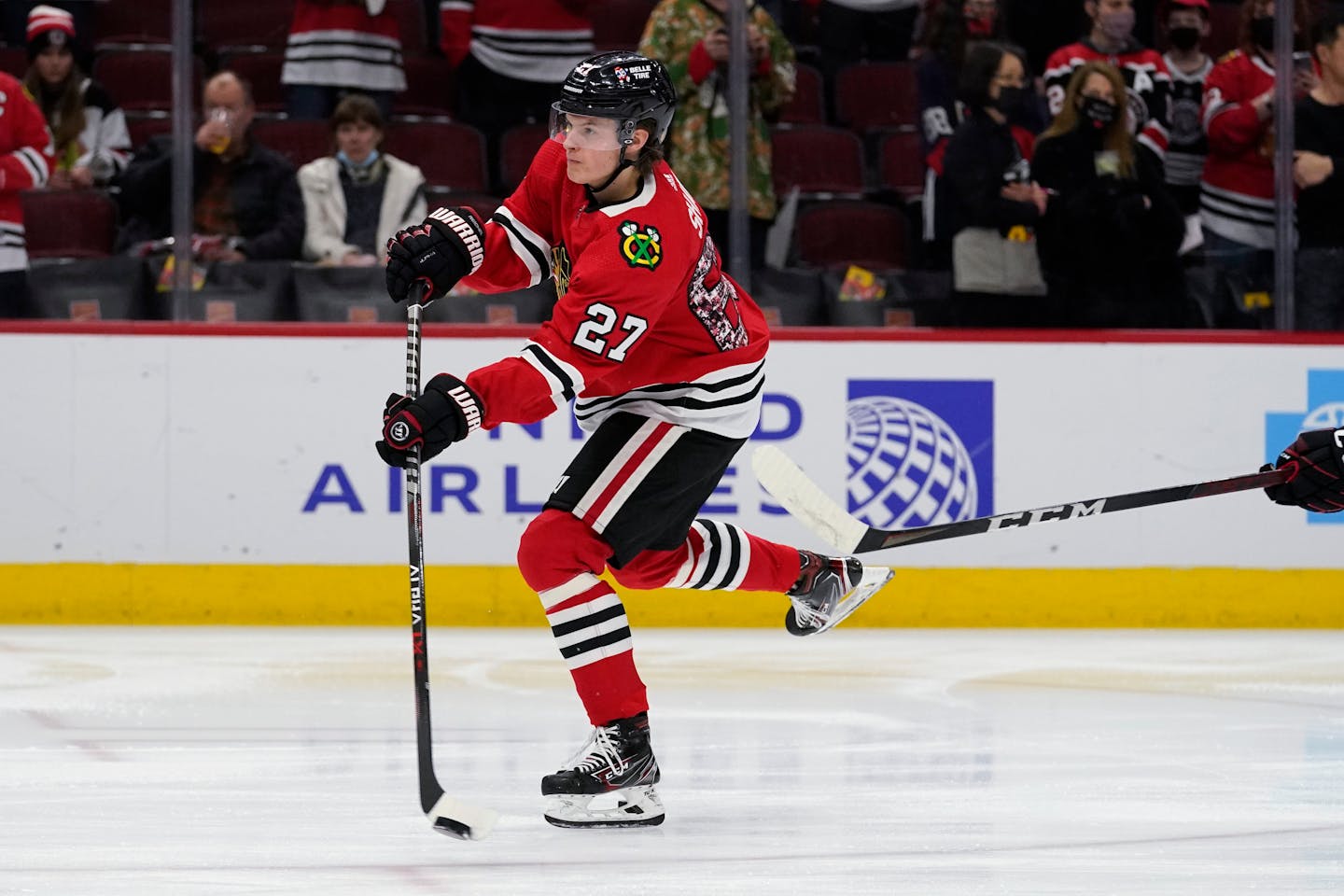 Chicago Blackhawks left wing Lukas Reichel (27) warms up with teammates before an NHL hockey game against the Montreal Canadiens in Chicago, Thursday, Jan. 13, 2022. (AP Photo/Nam Y. Huh)