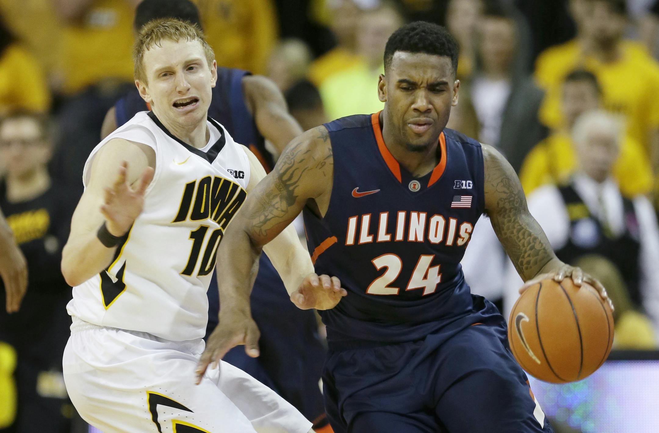 Illinois guard Rayvonte Rice (24) drives past Iowa guard Mike Gesell during the second half of an NCAA college basketball game on Saturday, March 8, 2014, in Iowa City, Iowa. Illinois won 66-63. (AP Photo/Charlie Neibergall)