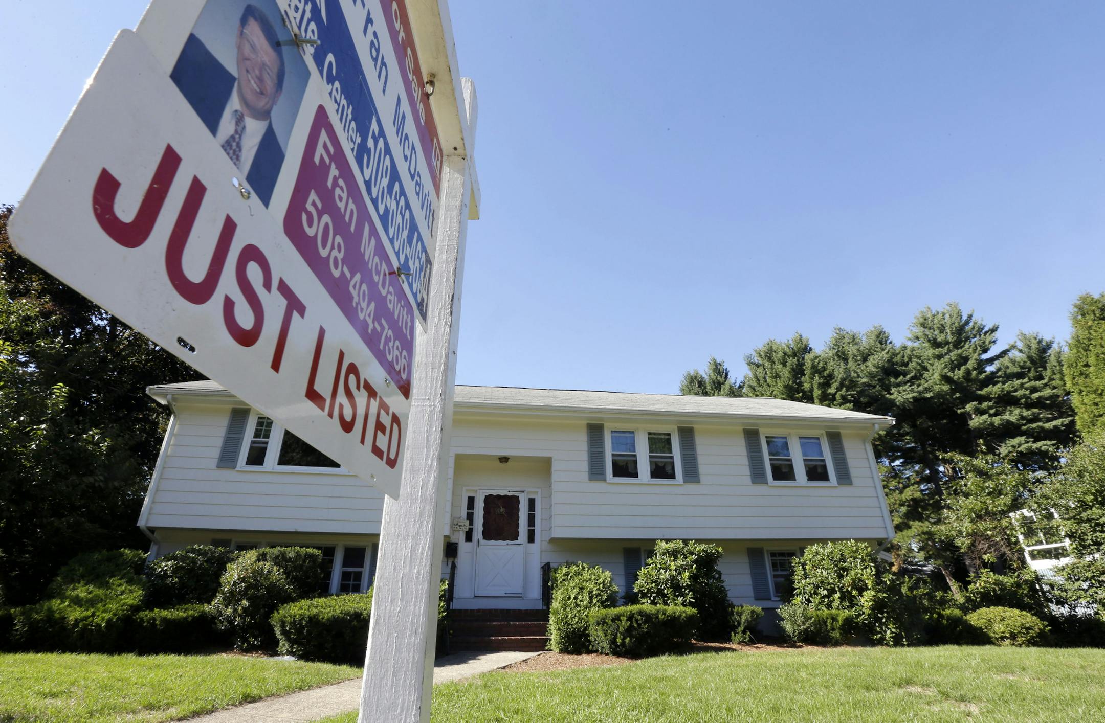 In this Wednesday, Sept. 18, 2013 photo a for sale sign hangs in front of a house in Walpole, Mass. U.S. home sales rose in August 2013 to the highest level since February 2007 as buyers rushed to close deals before interest rates rise further.( AP Photo/Steven Senne)