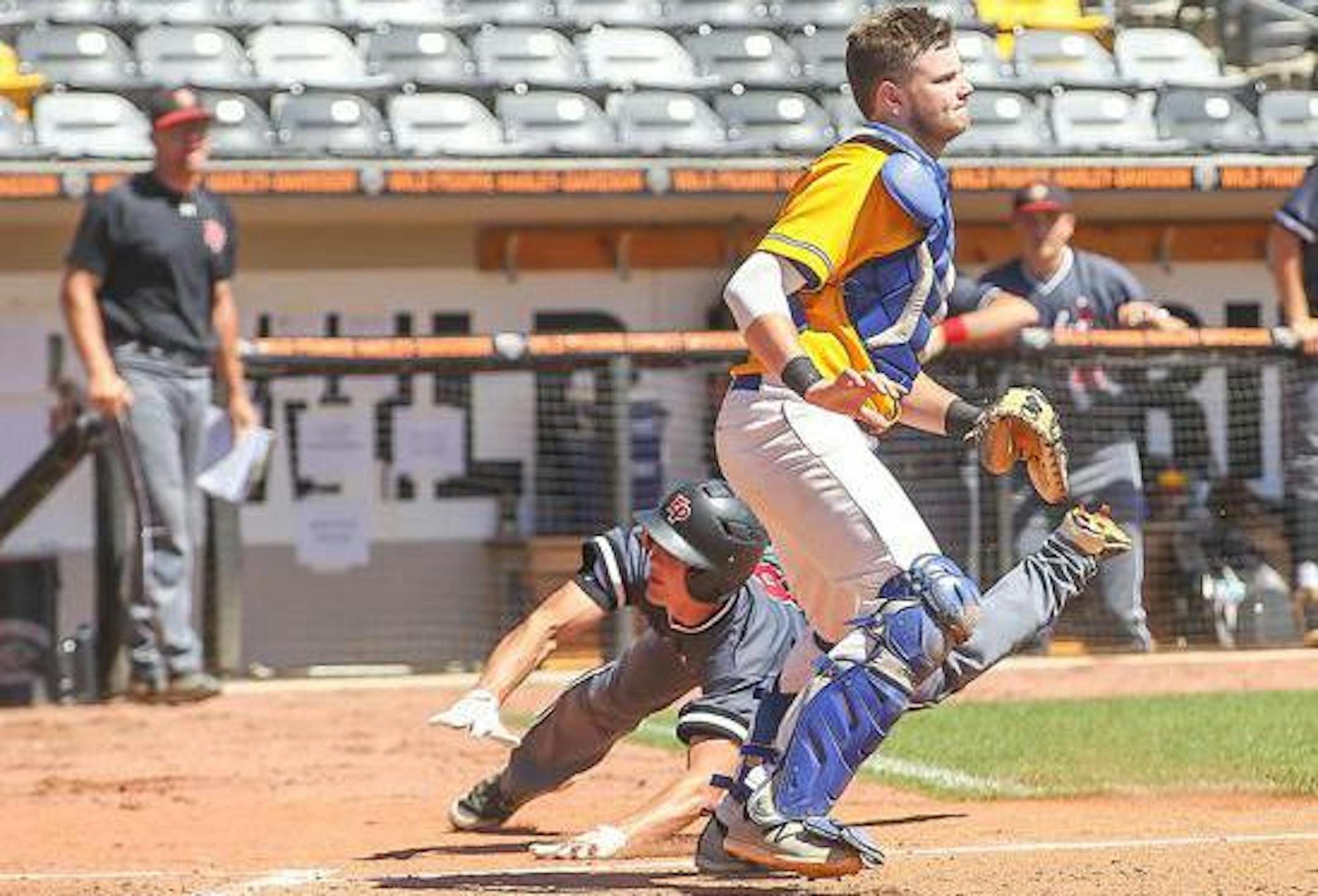 Eden Prairie's Mike Espe slides into home ahead of the throw to catcher Tyler Young, starting the scoring in the Eagles' 6-1 victory over Wayzata. Photo by Mark Hvidsten, SportsEngine