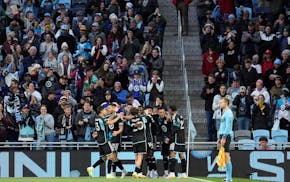 Teammates gather with Minnesota United forward Tani Oluwaseyi after he scored the first goal of the game Saturday against St. Louis at Allianz Field.