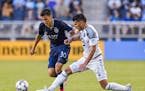 Minnesota United defender Kevin Venegas (22) kicked the ball away from Sporting Kansas City forward Daniel Salloi (30) during the first half of the ML