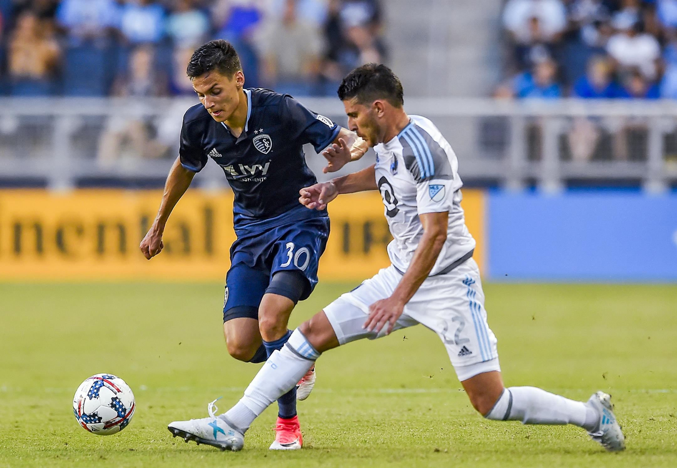 Minnesota United defender Kevin Venegas (22) kicked the ball away from Sporting Kansas City forward Daniel Salloi (30) during the first half of the MLS soccer match on Wednesday at Children's Mercy Park in Kansas City, Kan. Sporting Kansas City lead 2-0 at the half. ORG XMIT: B7310295257Z.1