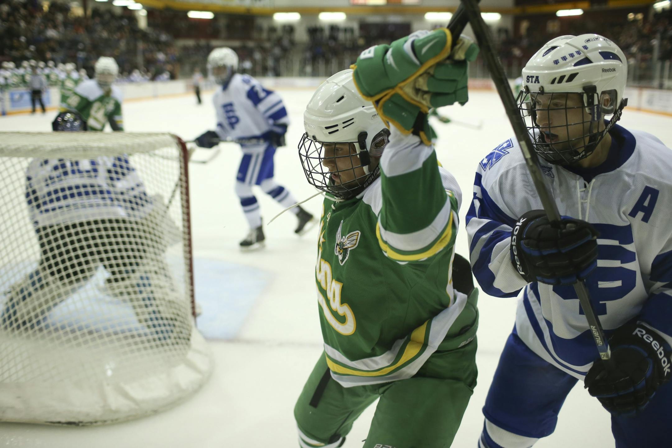 Edina faced St. Thomas Academy in their Schwan Cup gold division hockey game in December. Edina's Tyler Nanne and St. Thomas Academy's Tony Bretzman fought for position behind the St. Thomas net in the second period.