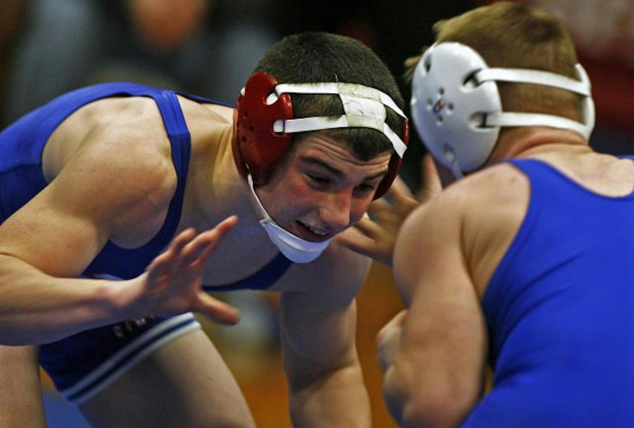 Simley's Jake Short (left) often wrestles above his actual weight of 135 pounds because it helps the team.