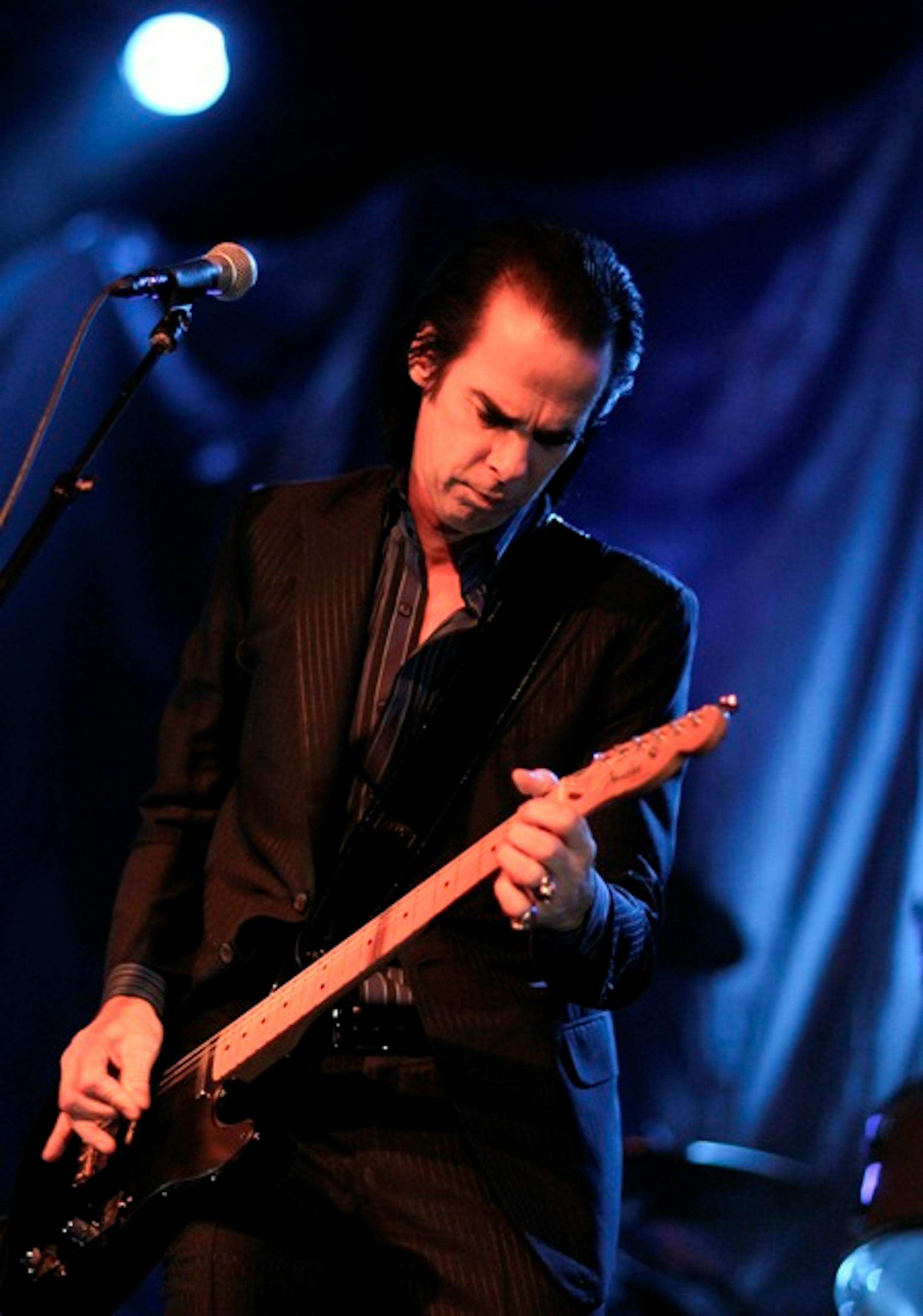 Nick Cave usually plays piano, but Grinderman is all about the guitar.