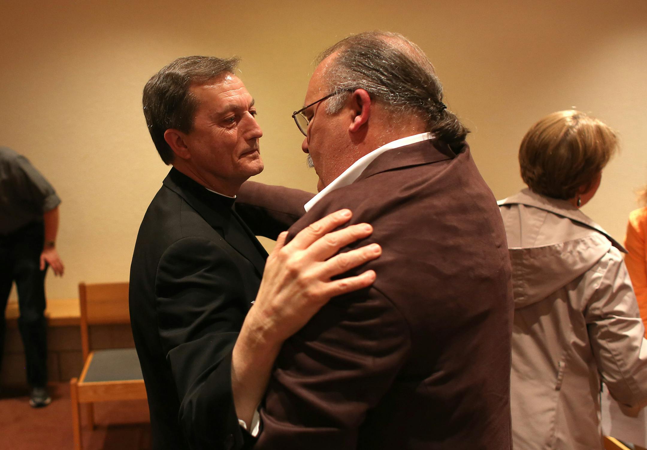 Rev. Charles Lachowitzer, vicar general of the Archdiocese, and Bob Schwiderski, of Minnesota SNAP, embraced and talked after an emotional meeting. ] (KYNDELL HARKNESS/STAR TRIBUNE) kyndell.harkness@startribune.com During a gathering at the Church of St. Paul in Ham Lake Min., Thursday, May 8, 2014.