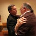 Rev. Charles Lachowitzer, vicar general of the Archdiocese, and Bob Schwiderski, of Minnesota SNAP, embraced and talked after an emotional meeting. ] 