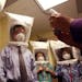 Doctors and nurses wear hoods as they test the seal of N95 respiratory masks during a training at the La Clinica San Antonio Neighborhood Health Cente