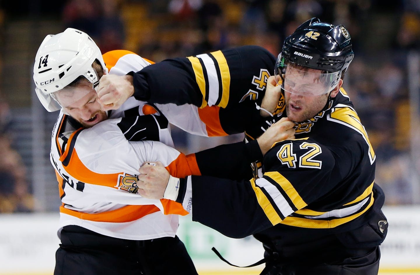 Philadelphia Flyers' Sean Couturier (14) and Boston Bruins' David Backes (42) fight during the first period of an NHL preseason hockey game in Boston, Saturday, Oct. 8, 2016. (AP Photo/Michael Dwyer)