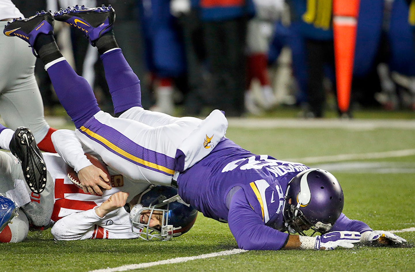 Minnesota Vikings defensive tackle Tom Johnson, right, sacks New York Giants quarterback Eli Manning during the first half of an NFL football game, Sunday, Dec. 27, 2015, in Minneapolis.