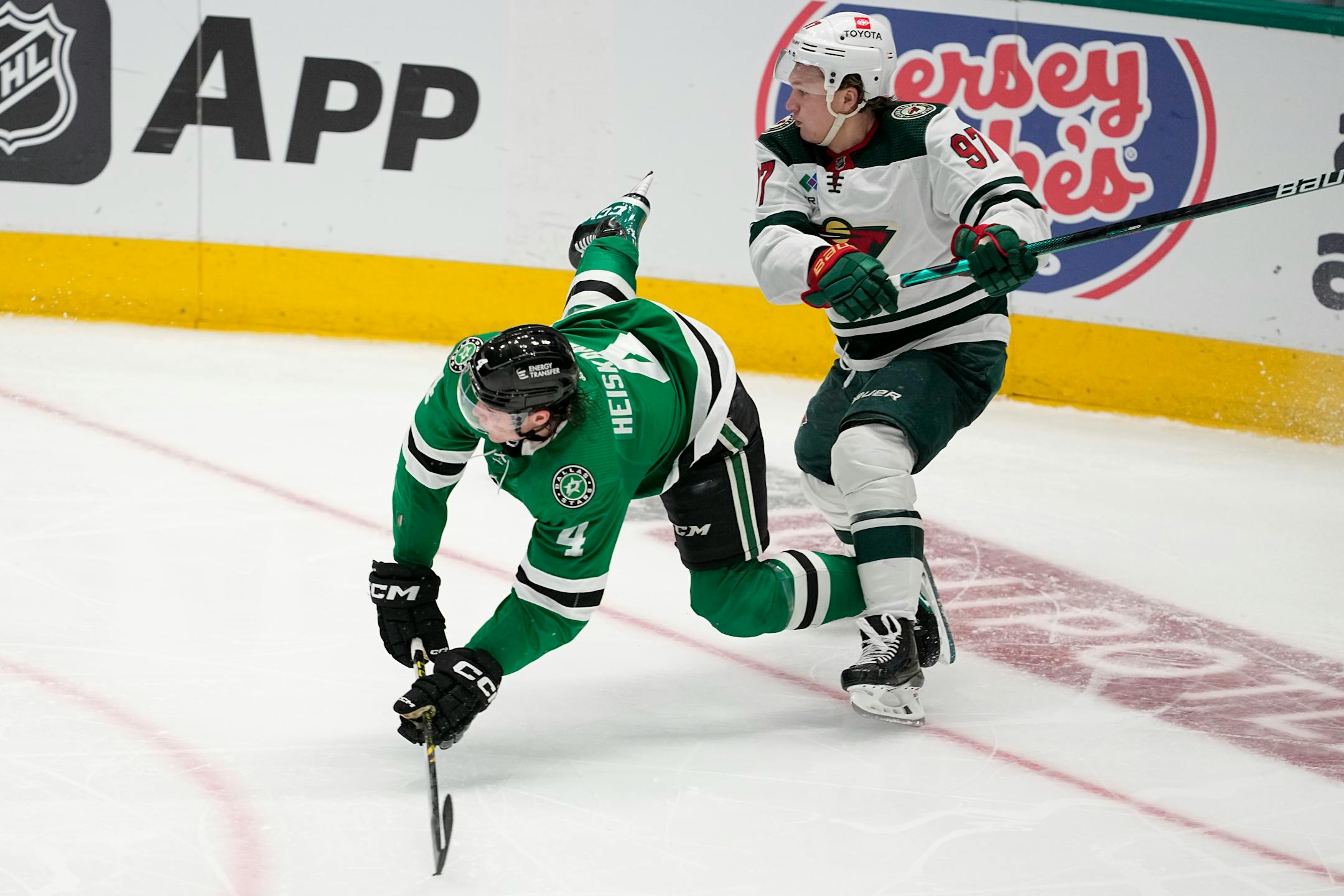 Dallas Stars' Miro Heiskanen (4) is sent flying by Minnesota Wild's Kirill Kaprizov (97) during the third period of Game 1.